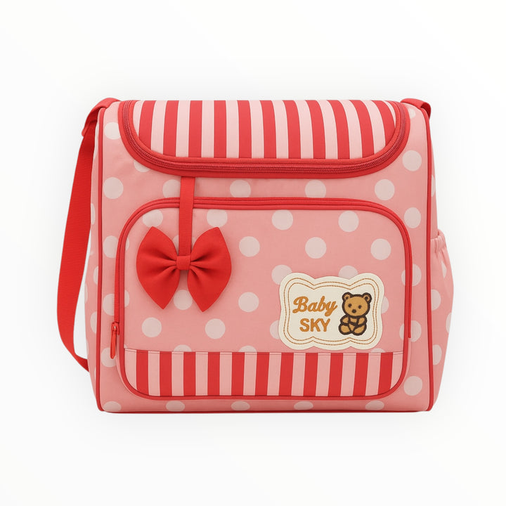 Polka dot diaper bag with bow, side bottle holder, and front pocket
