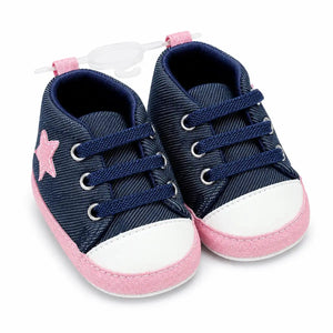 Navy blue denim baby first walker shoes with pink star detail, elastic laces and soft sole – angled view