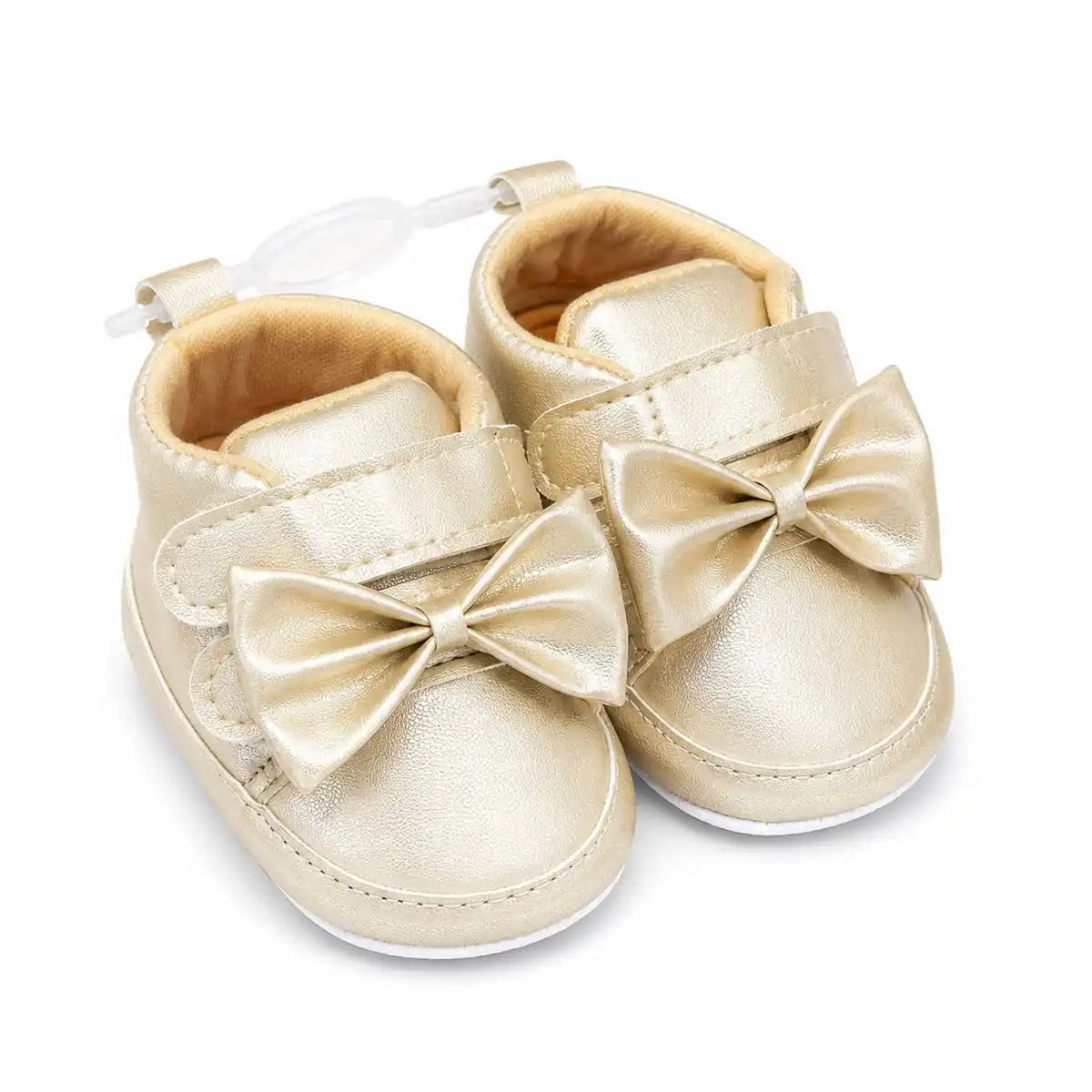 Metallic gold baby girl first walker shoes with decorative bow, hook and loop strap and soft sole – angled view