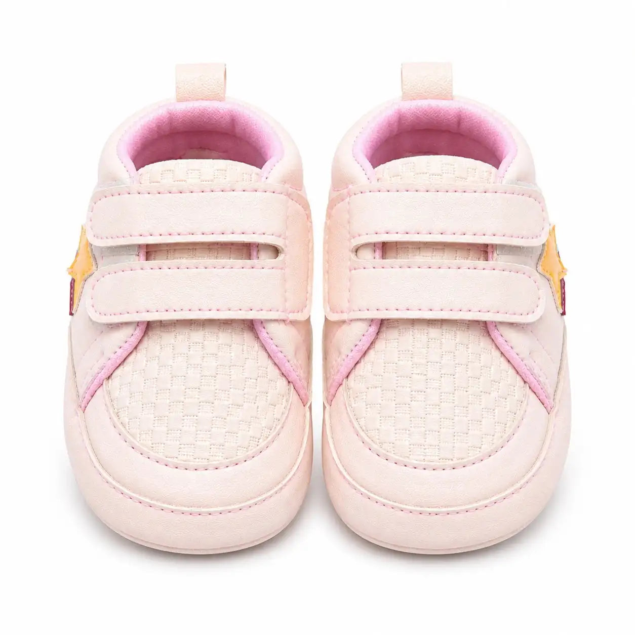Front view of baby pink double strap shoes for baby girls with textured toe and soft cushioned interior
