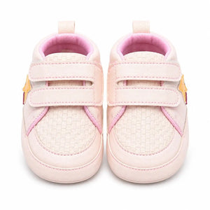 Front view of baby pink double strap shoes for baby girls with textured toe and soft cushioned interior