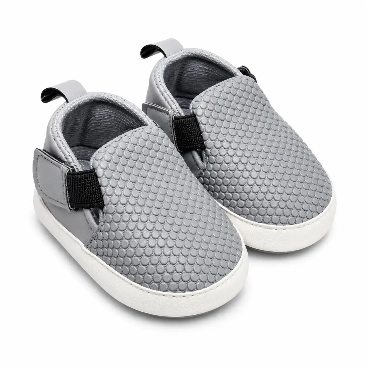 Light grey textured baby slip-on soft sole first walker shoes with elastic side panels – angled view