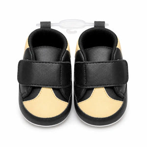 Baby black and beige soft sole first walker shoes with secure strap closure – front view
