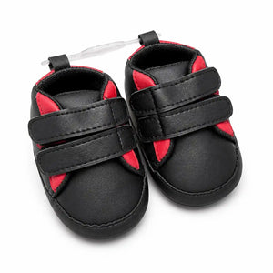 Black and red baby first walker shoes with double Velcro straps and soft sole – front angled view