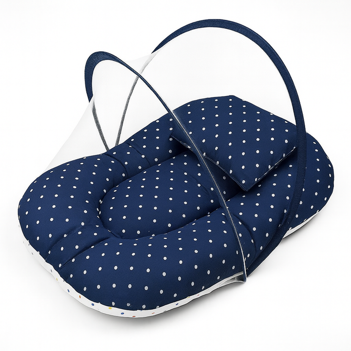 Dark blue polka dot baby carry nest with protective mosquito net – stylish and safe sleeping nest for newborns.
