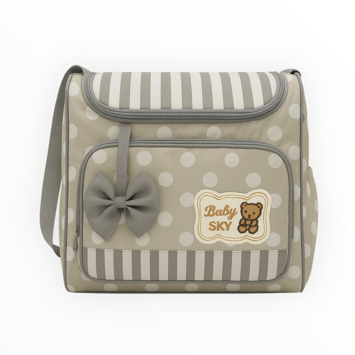 Polka dot diaper bag with bow, side bottle holder, and front pocket
