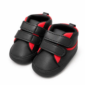 Black and red baby soft sole first walker shoes with double hook-and-loop straps – angled view