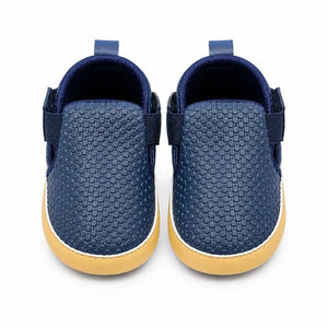 Navy blue textured slip-on baby first walker shoes with elastic side panels and soft sole – front view