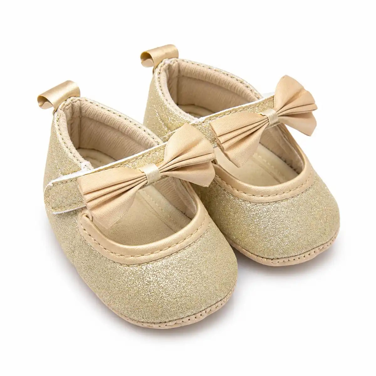 Baby girl golden champagne glitter bow soft sole first walker shoes – angled view