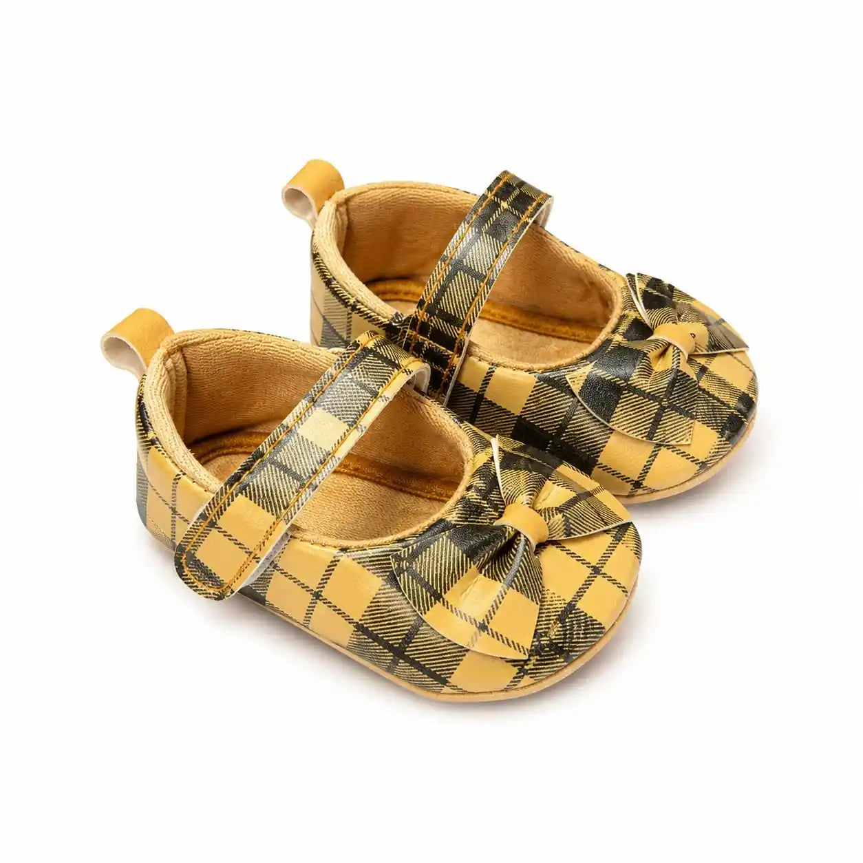 Mustard yellow and black plaid baby girl soft sole shoes with decorative bow and Velcro strap – angled view