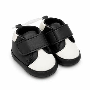Baby black and white soft sole first walker shoes with hook-and-loop strap – angled view