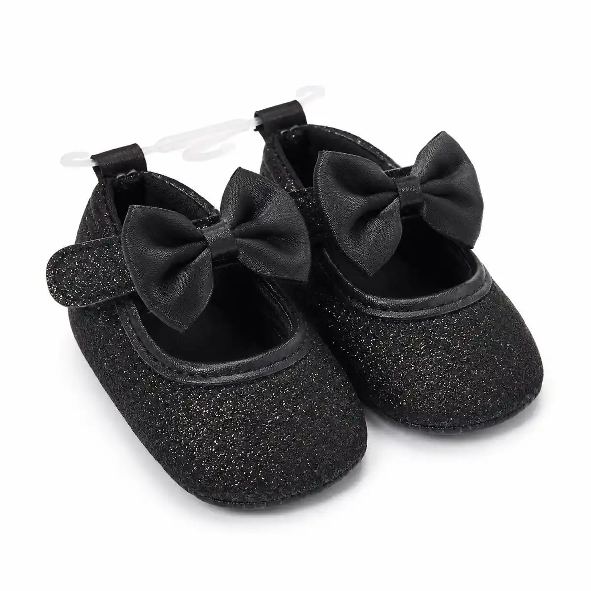 Baby girls black glitter bow soft sole shoes with hook-and-loop strap – angled view