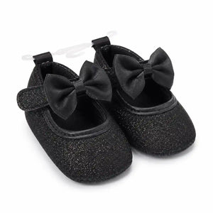 Baby girls black glitter bow soft sole shoes with hook-and-loop strap – angled view