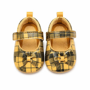 Mustard yellow and black plaid bow baby girl first walker shoes with hook-and-loop strap – front view