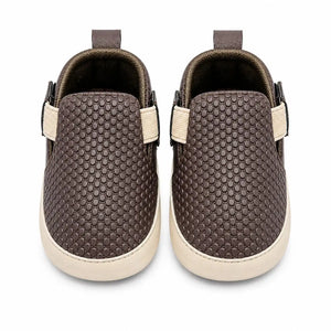 Front view of brown textured baby slip-on first walker shoes with cushioned lining and elastic side closure