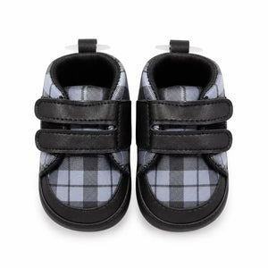 Black and grey checkered baby first walker shoes with double hook-and-loop straps – front view