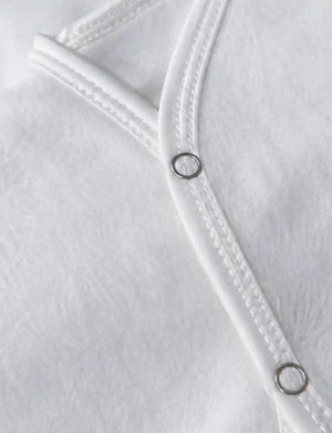 White baby sleeveless vest snap button and soft fabric close up in Pakistan