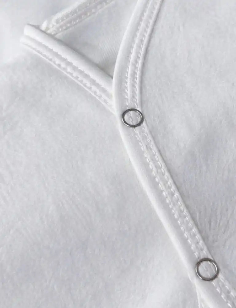 White baby sleeveless vest snap button and soft fabric close up in Pakistan