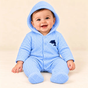 Baby wearing light blue hooded quilted winter romper with footies and dolphin applique in seated pose