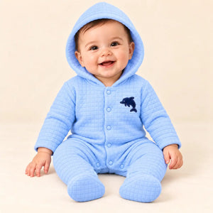 Baby wearing light blue square quilted hooded winter romper with attached footies and dolphin applique