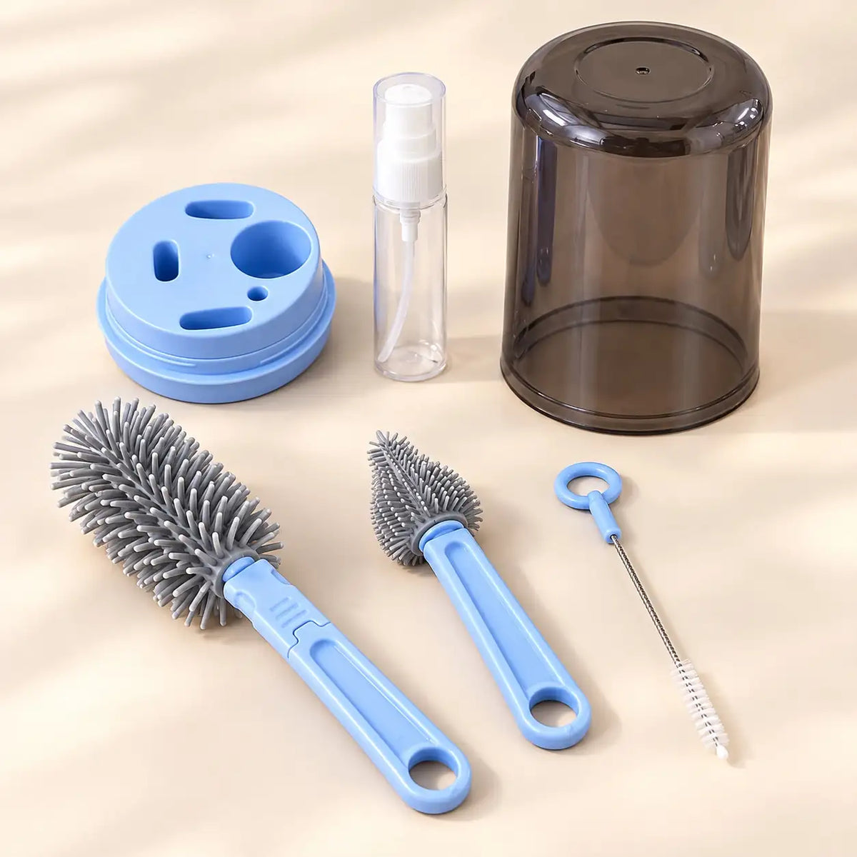 Blue 6-in-1 baby bottle brush cleaning set with bottle brush, nipple brush, straw brush, dispenser and dust cover