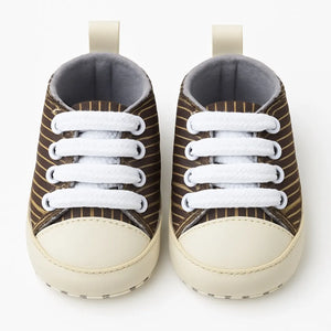 Striped baby sneakers front view with soft rubber sole and white laces