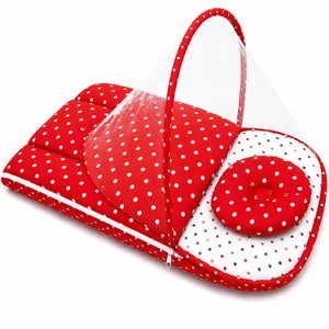 Red polka dot baby carry nest with pillow shown in portable folded view