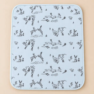 Light blue baby changing mat with grey rabbit illustrations