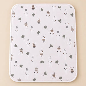 White cotton baby changing sheet with cute bunny and green leaf print