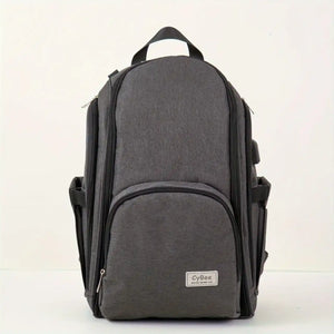 Dark grey baby diaper backpack with multiple compartments and side bottle pockets, front view