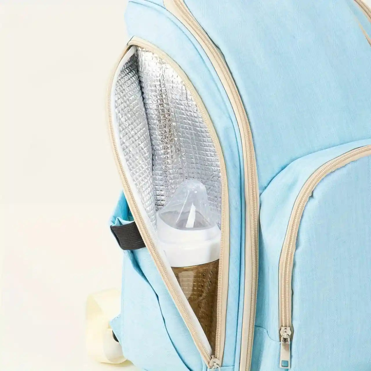 Sky blue baby diaper backpack with insulated side bottle compartment for keeping a feeder bottle
