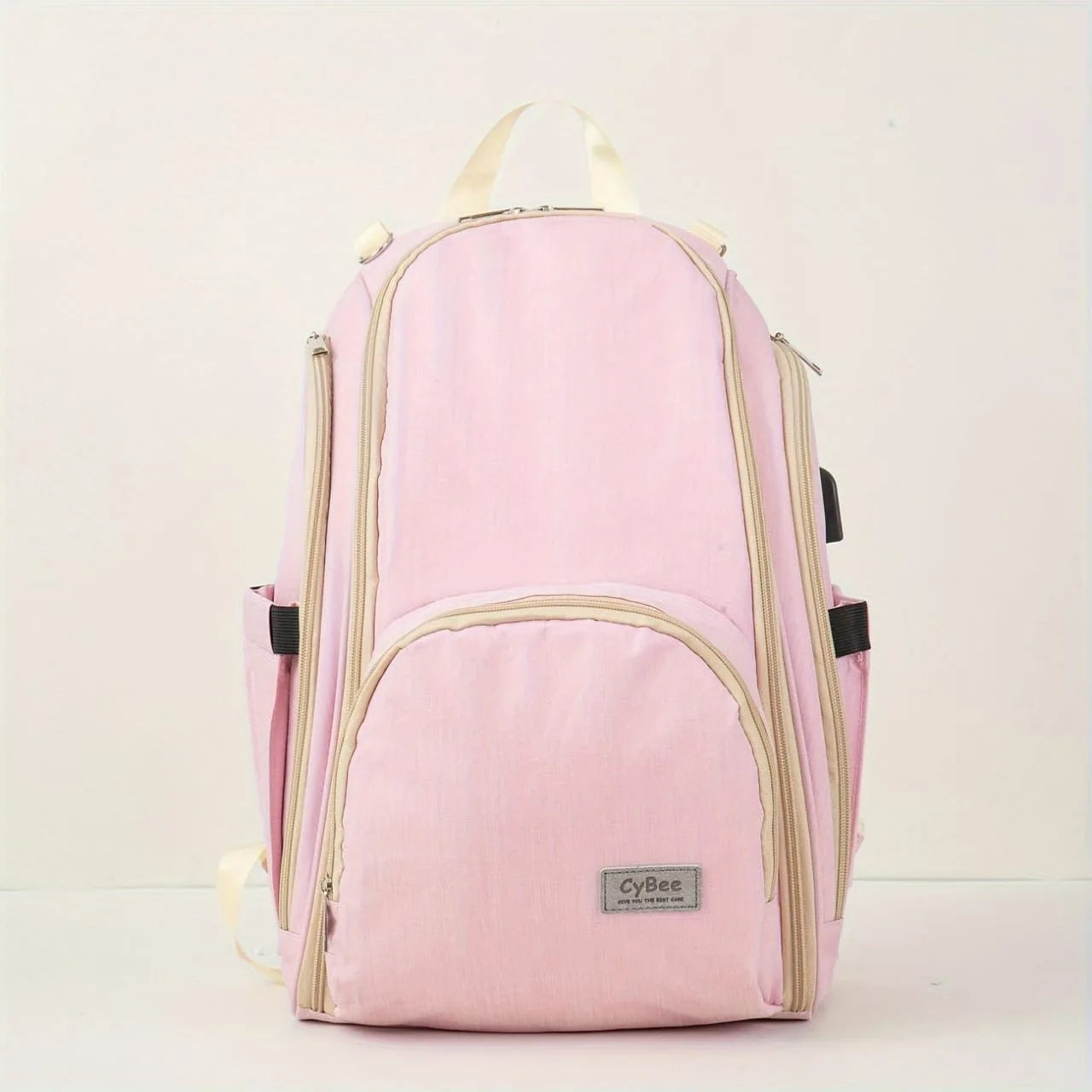 Pink baby diaper backpack with multiple zip compartments and side bottle pockets, front view