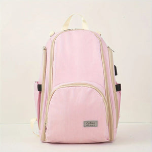 Pink baby diaper backpack with multiple zip compartments and side bottle pockets, front view