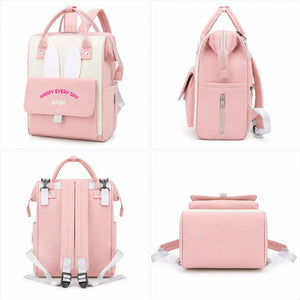 Baby pink diaper backpack bag showing front, side, back and bottom views