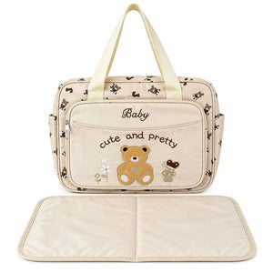 Beige teddy baby diaper bag with foldable changing mat and carry handles