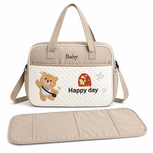 Beige baby diaper bag with spacious compartments and matching changing mat