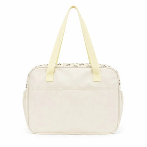 Cream baby diaper bag back view with strong carry handles