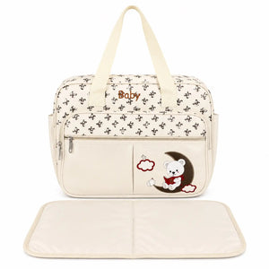 Cream baby print diaper bag with matching foldable changing sheet