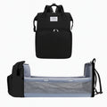 Black baby diaper backpack with foldable baby bed and mesh side panels