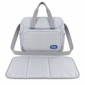 Grey baby diaper bag with multiple compartments and matching foldable changing mat