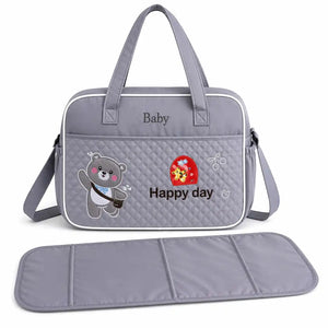 Grey baby diaper bag with shoulder strap and foldable changing mat