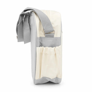 Cream baby diaper bag side view showing adjustable shoulder strap