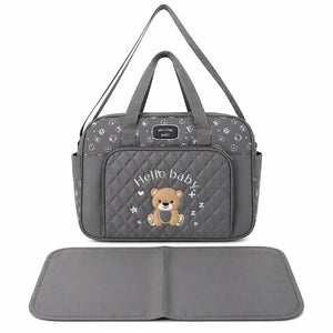 Grey baby diaper bag with adjustable shoulder strap and matching changing mat