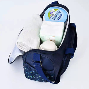 Dark blue baby travel organizer set with waterproof changing pad in use