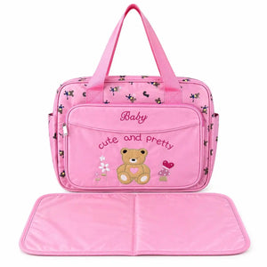Pink teddy baby diaper bag with front zip pocket and changing mat