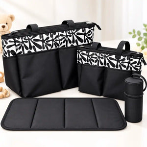 4-piece black baby diaper bag set with black and white abstract print, matching bottle holder and padded changing mat