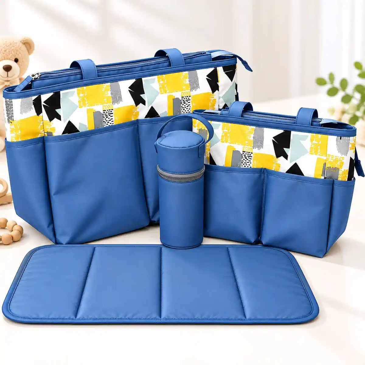 4-piece blue baby diaper bag set with geometric print, large and small diaper bags, bottle holder and padded changing mat