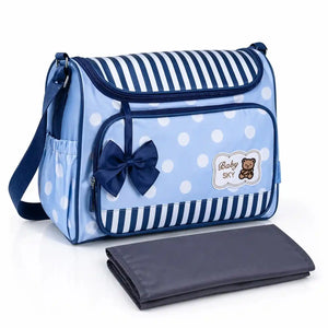 Blue baby diaper bag with adjustable shoulder strap and striped polka dot design