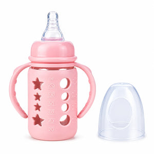 Pink baby feeding bottle with handles, nipple and protective cap