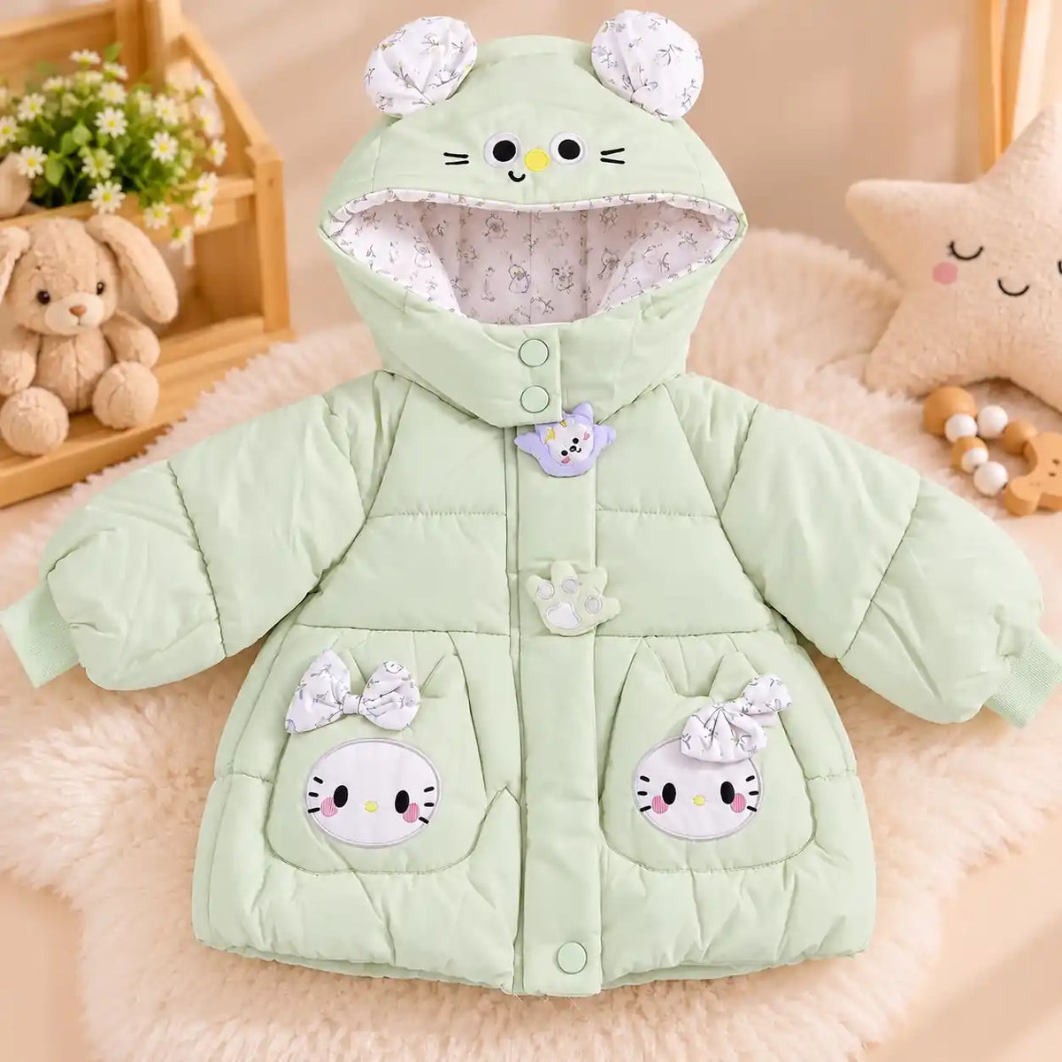 Mint green hooded baby winter puffer jacket with cute character pockets, decorative bows and ear detailing